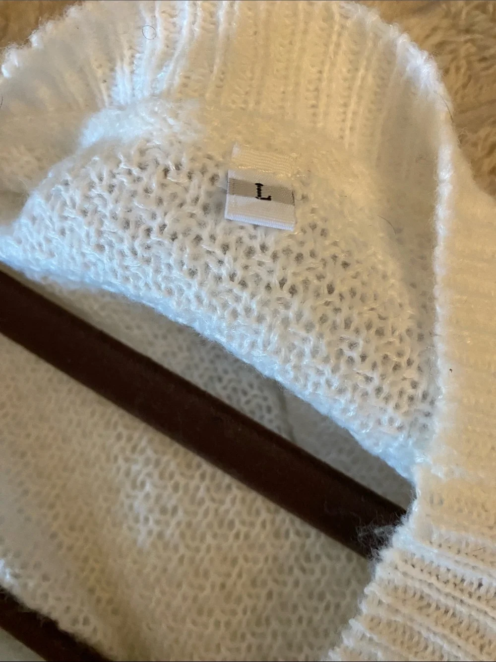 White Women’s Knit Sweater with Tie Details in the Back.